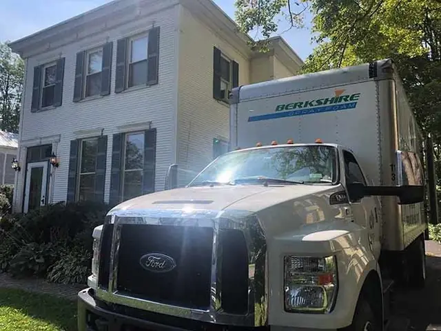 A Berkshire Spray Foam truck, the same fleet and the same crew, parked outside a home